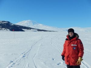 Dr Boardman in Antarctica with Mt Erebus in the background
