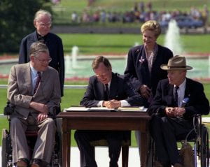 President George H.W. Bush signs the Americans with Disabilities Act 